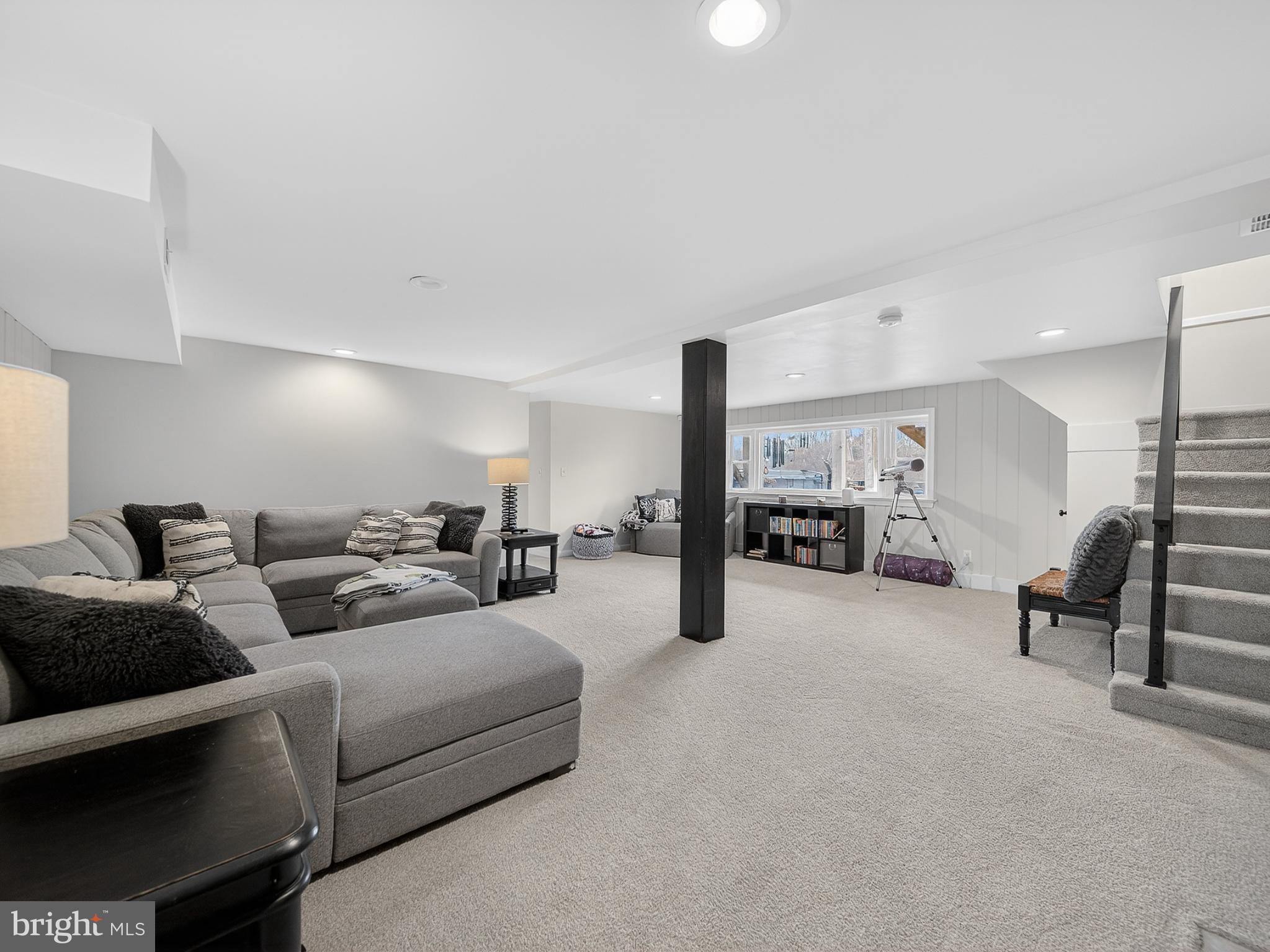 8746 Meetze Road Warrenton, VA 20187 - Photo 32 of 48 a living room with furniture and a flat screen tv