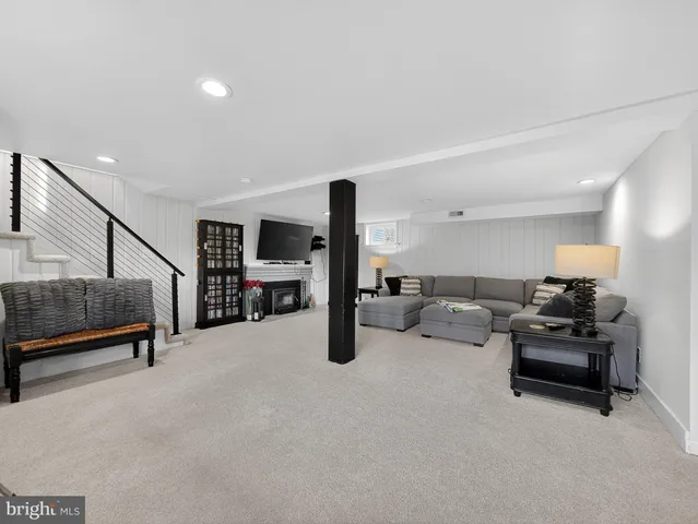 a living room with furniture gym equipment and a view of staircase