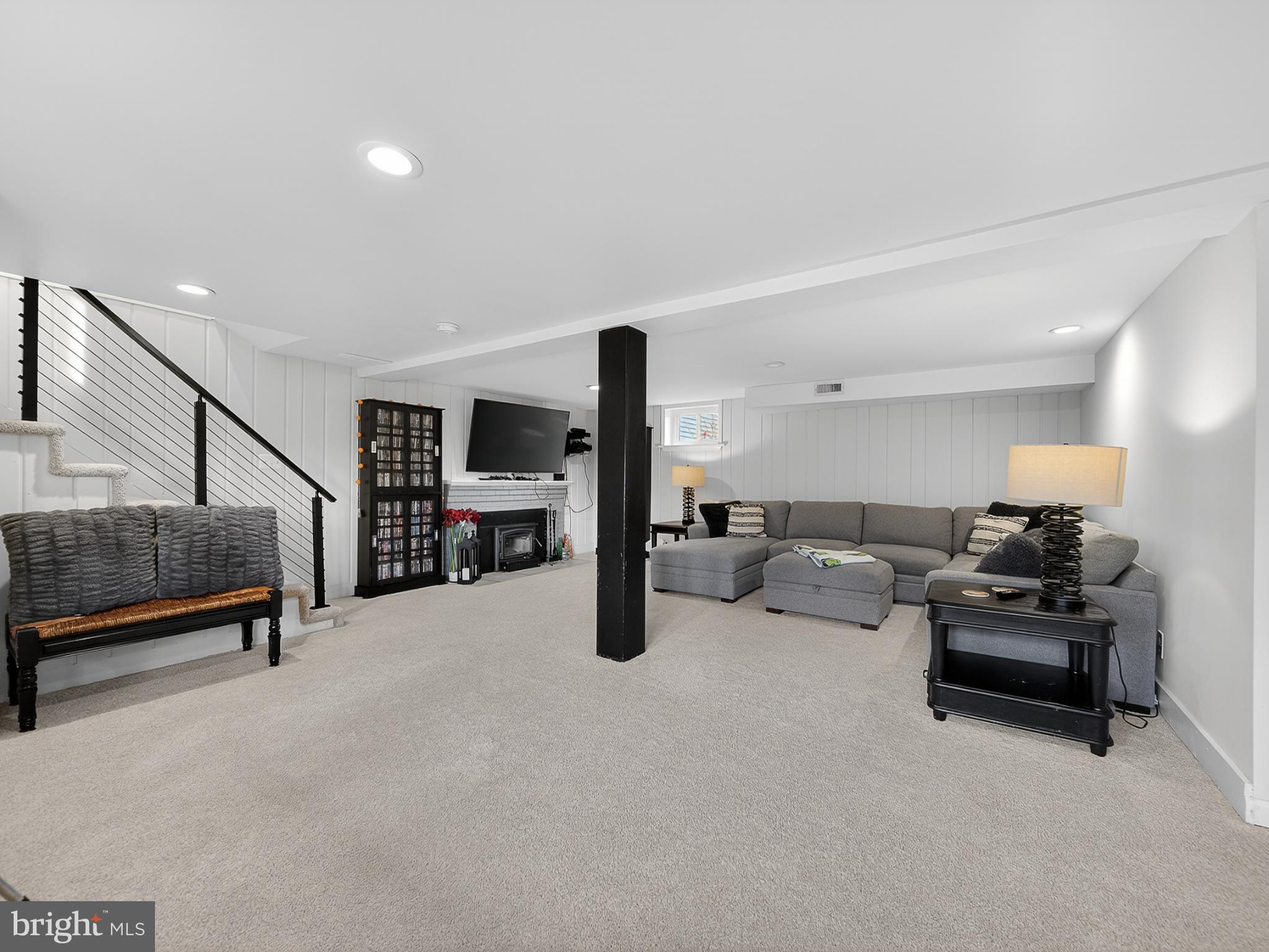 8746 Meetze Road Warrenton, VA 20187 - Photo 33 of 48 a living room with furniture gym equipment and a view of staircase