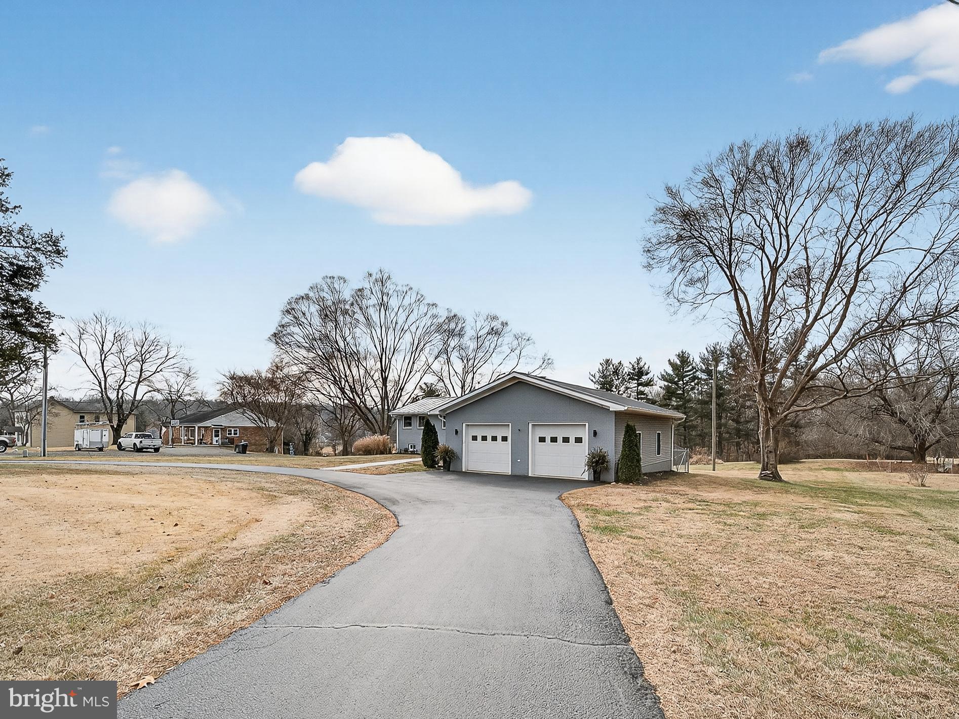 8746 Meetze Road Warrenton, VA 20187 - Photo 4 of 48 a front view of a house with a yard covered in snow
