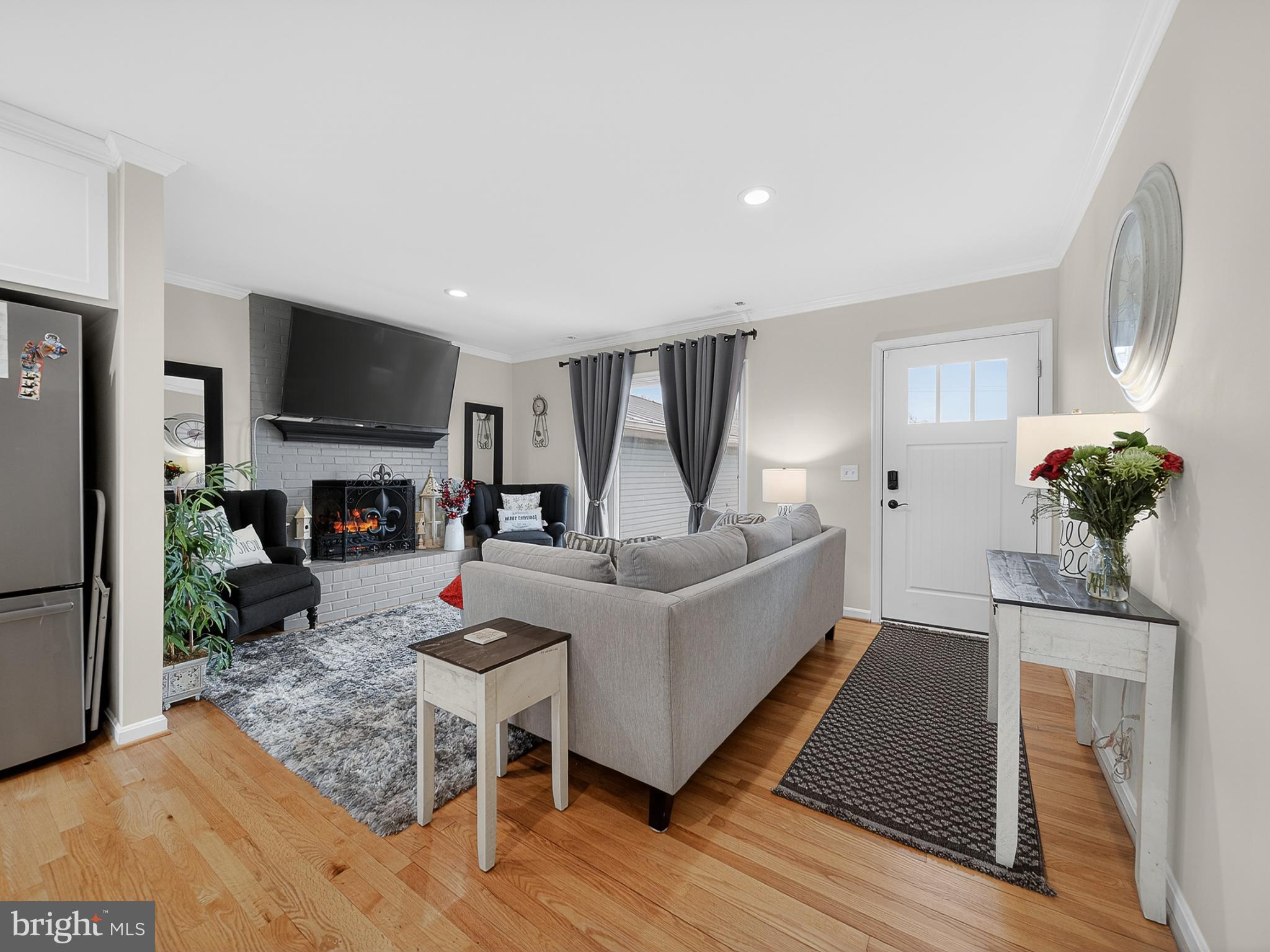 8746 Meetze Road Warrenton, VA 20187 - Photo 5 of 48 a living room with furniture a flat screen tv and a fireplace