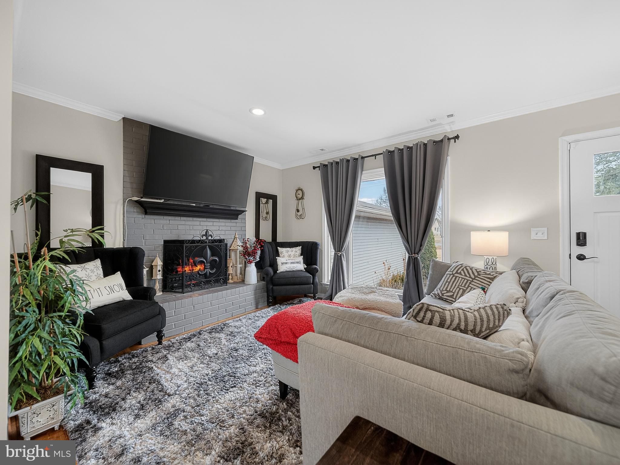 8746 Meetze Road Warrenton, VA 20187 - Photo 6 of 48 a living room with furniture a flat screen tv and a fireplace