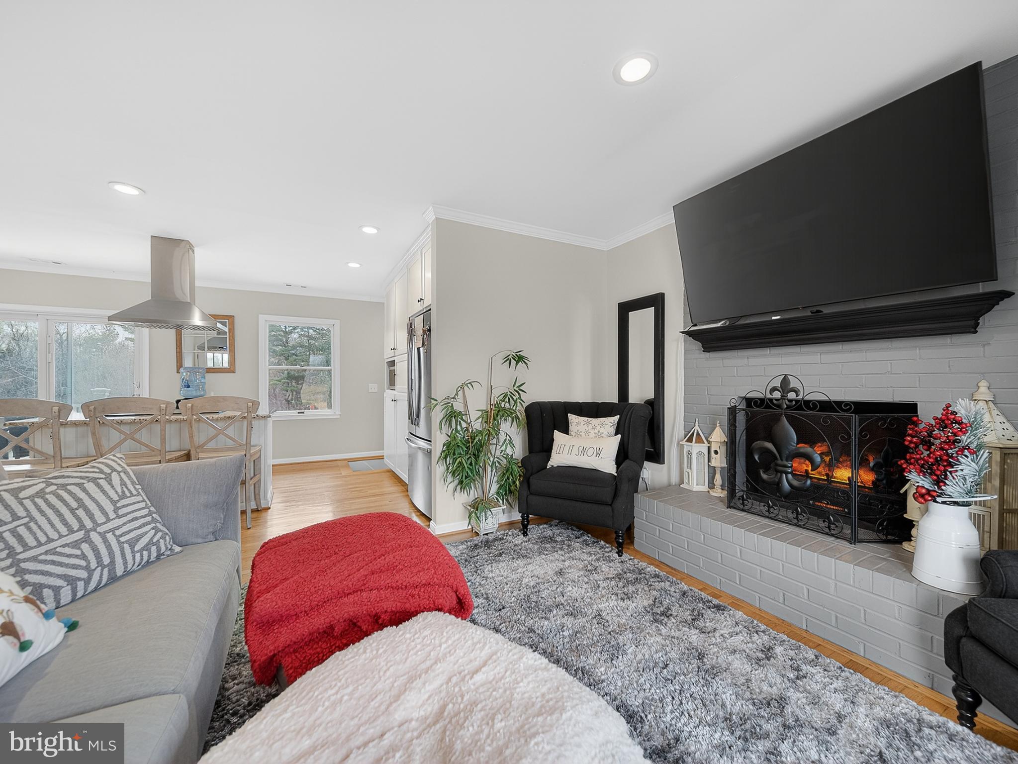 8746 Meetze Road Warrenton, VA 20187 - Photo 7 of 48 a living room with furniture a flat screen tv and a fireplace