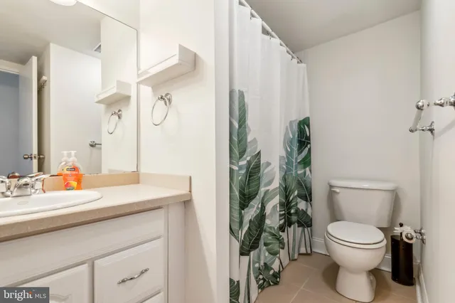 a bathroom with a toilet a sink and a mirror
