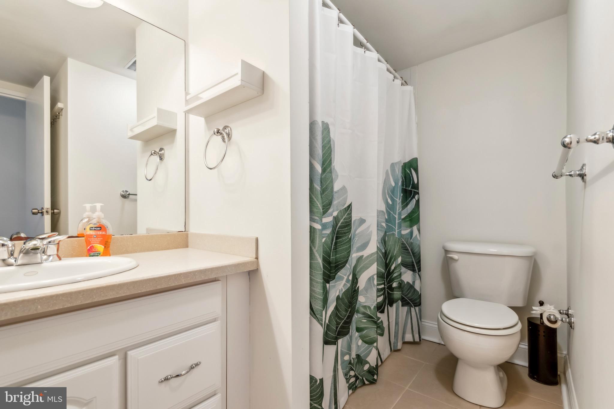 2001 Hamilton Street, Unit 927 Philadelphia, PA 19130 - Photo 13 of 26 a bathroom with a toilet a sink and a mirror