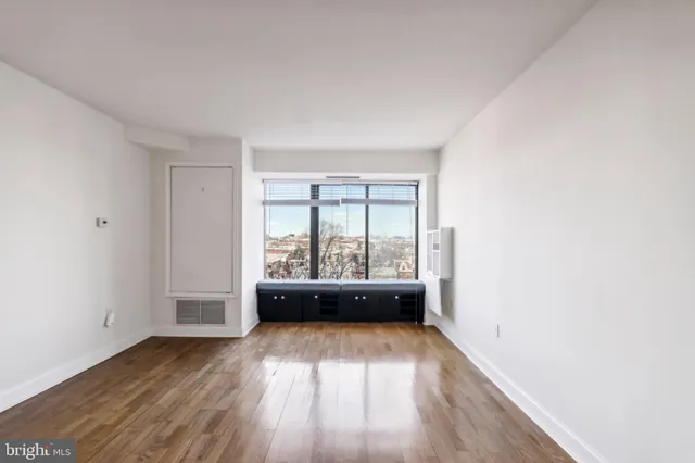 a view of room with window and hardwood floor