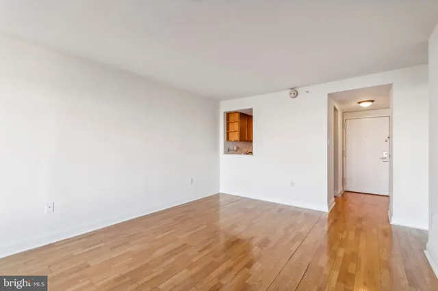 a view of an empty room with wooden floor