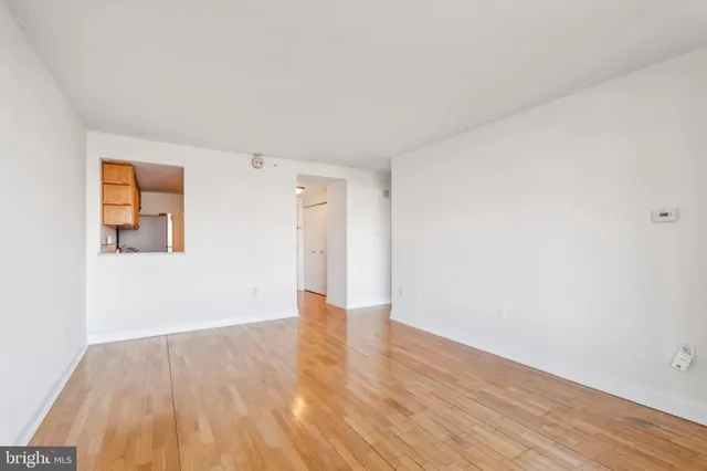 a view of an empty room and wooden floor