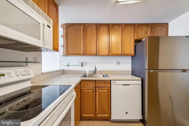 a kitchen with a refrigerator stove and sink