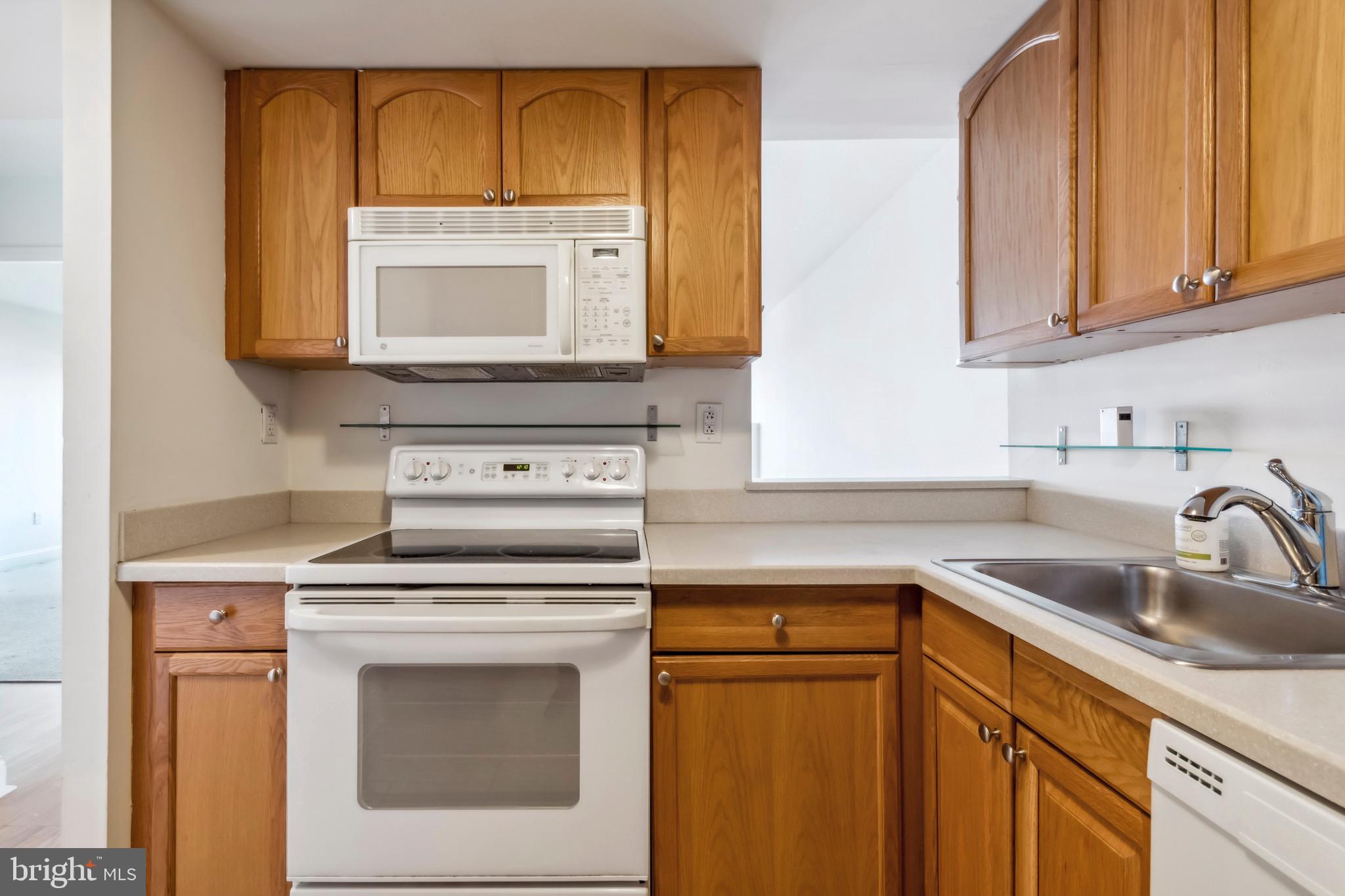 2001 Hamilton Street, Unit 927 Philadelphia, PA 19130 - Photo 9 of 26 a kitchen with sink a microwave and cabinets