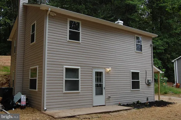 a kitchen with stainless steel appliances granite countertop a refrigerator a stove and wooden cabinets