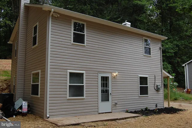 a kitchen with stainless steel appliances granite countertop a refrigerator a stove and wooden cabinets