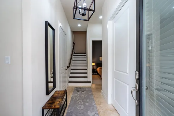 a view of a hallway with a room and stairs