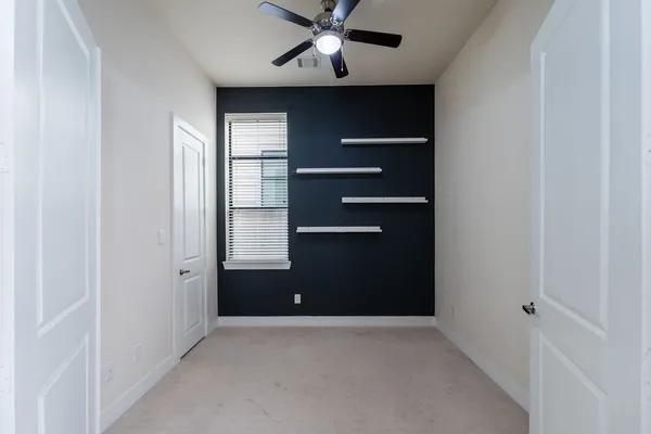 a view of room with a ceiling fan