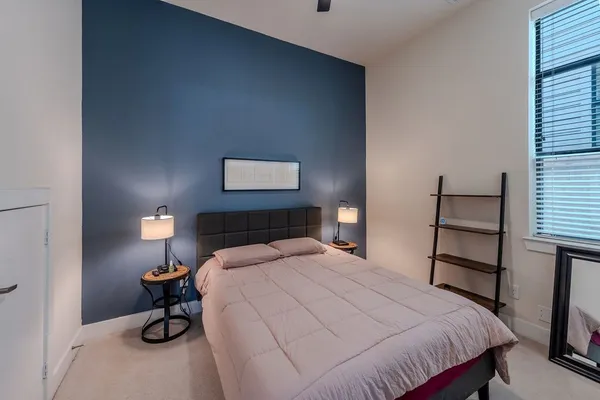 a bedroom with a bed and a lamp on table