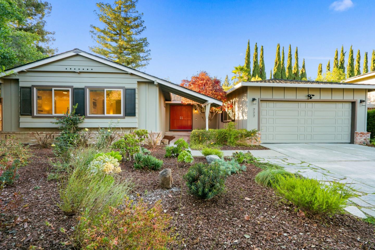 777 Rustic Lane Mountain View, CA 94040 - Photo 1 of 44 a front view of a house with a garden