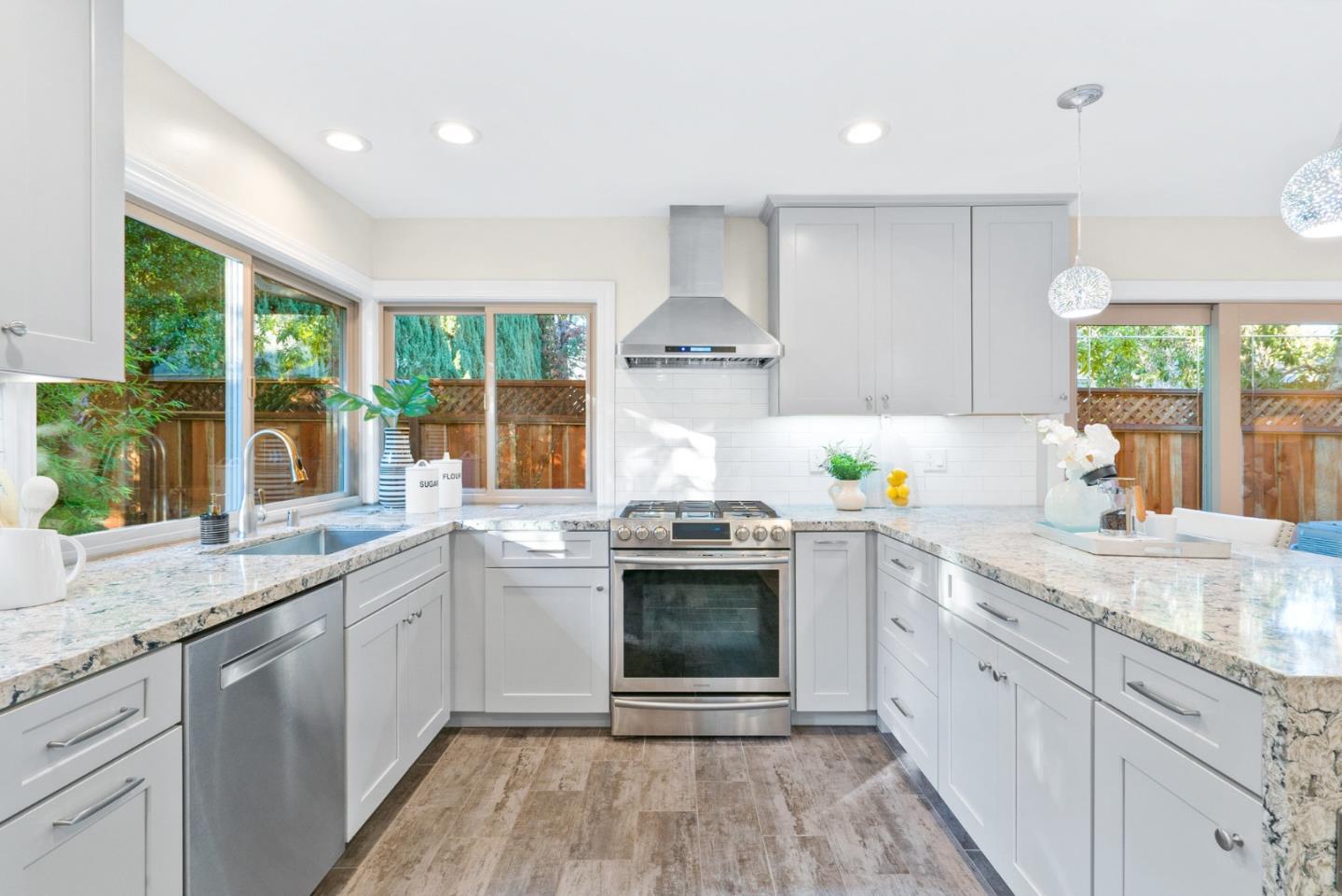 777 Rustic Lane Mountain View, CA 94040 - Photo 18 of 44 a kitchen with stainless steel appliances granite countertop a stove and a sink