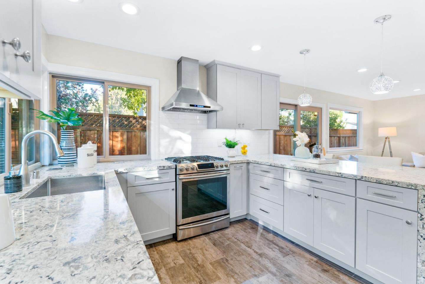 777 Rustic Lane Mountain View, CA 94040 - Photo 19 of 44 a kitchen with stainless steel appliances granite countertop a sink stove and a large window