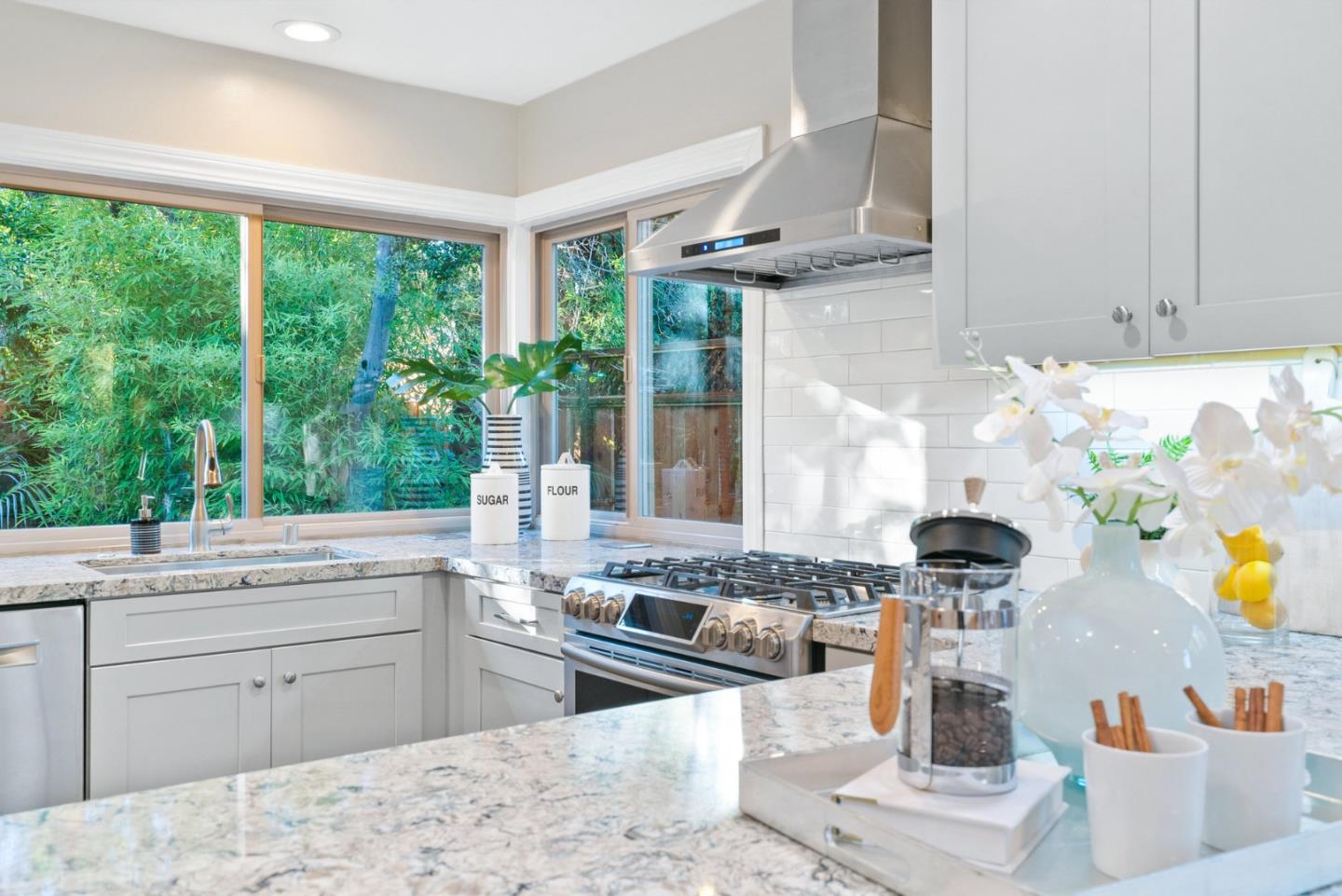 777 Rustic Lane Mountain View, CA 94040 - Photo 20 of 44 a kitchen with stainless steel appliances granite countertop a stove a sink and a white cabinets