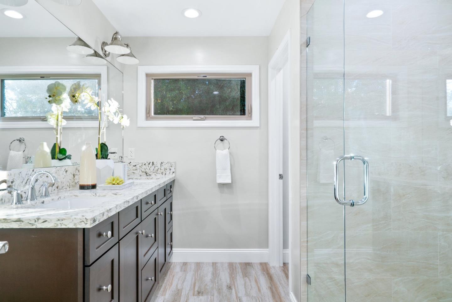 777 Rustic Lane Mountain View, CA 94040 - Photo 26 of 44 a bathroom with a granite countertop sink a shower and a mirror