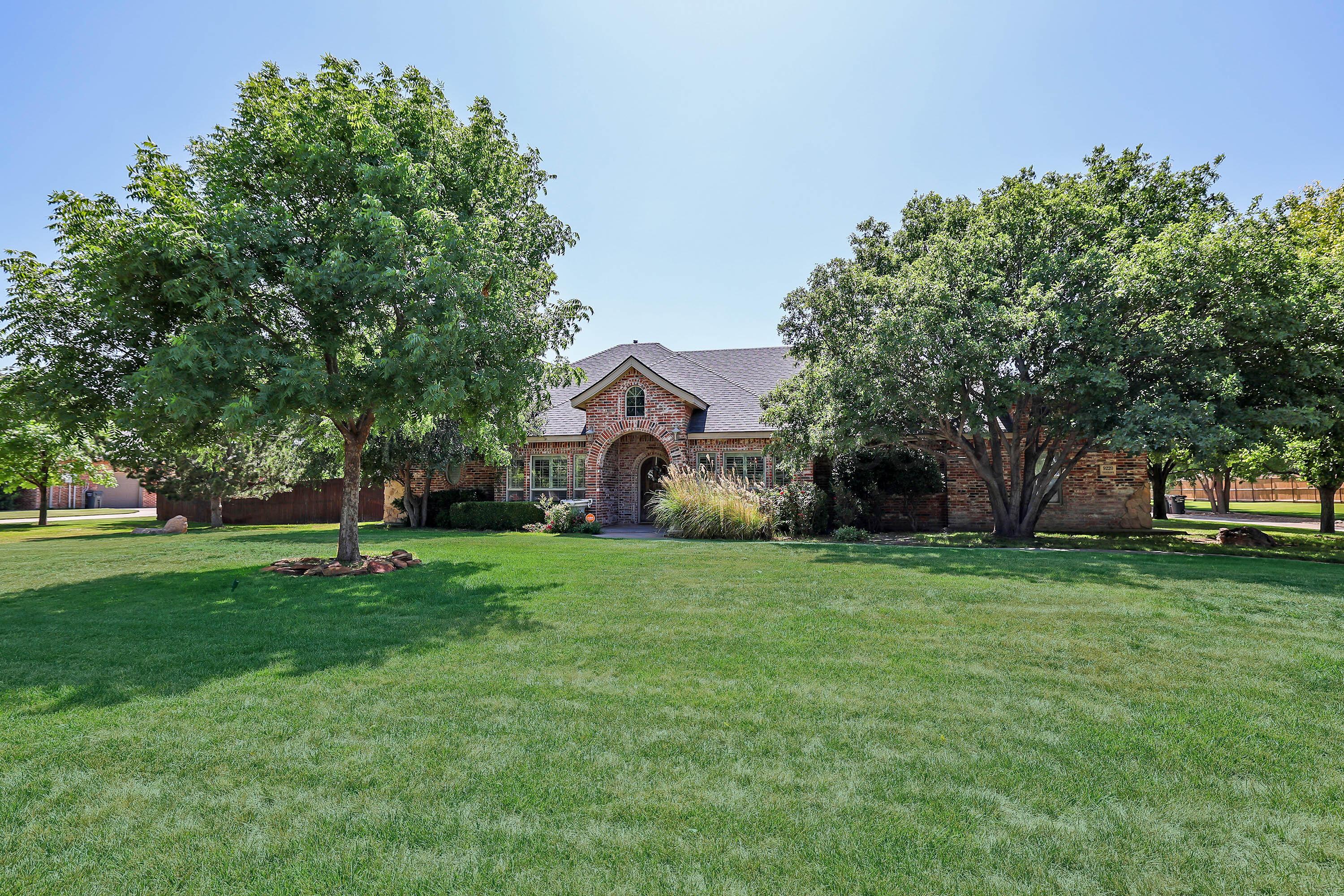 9220 Greyhawk Road Amarillo, TX 79119 - Photo 1 of 50 a front view of a house with a yard