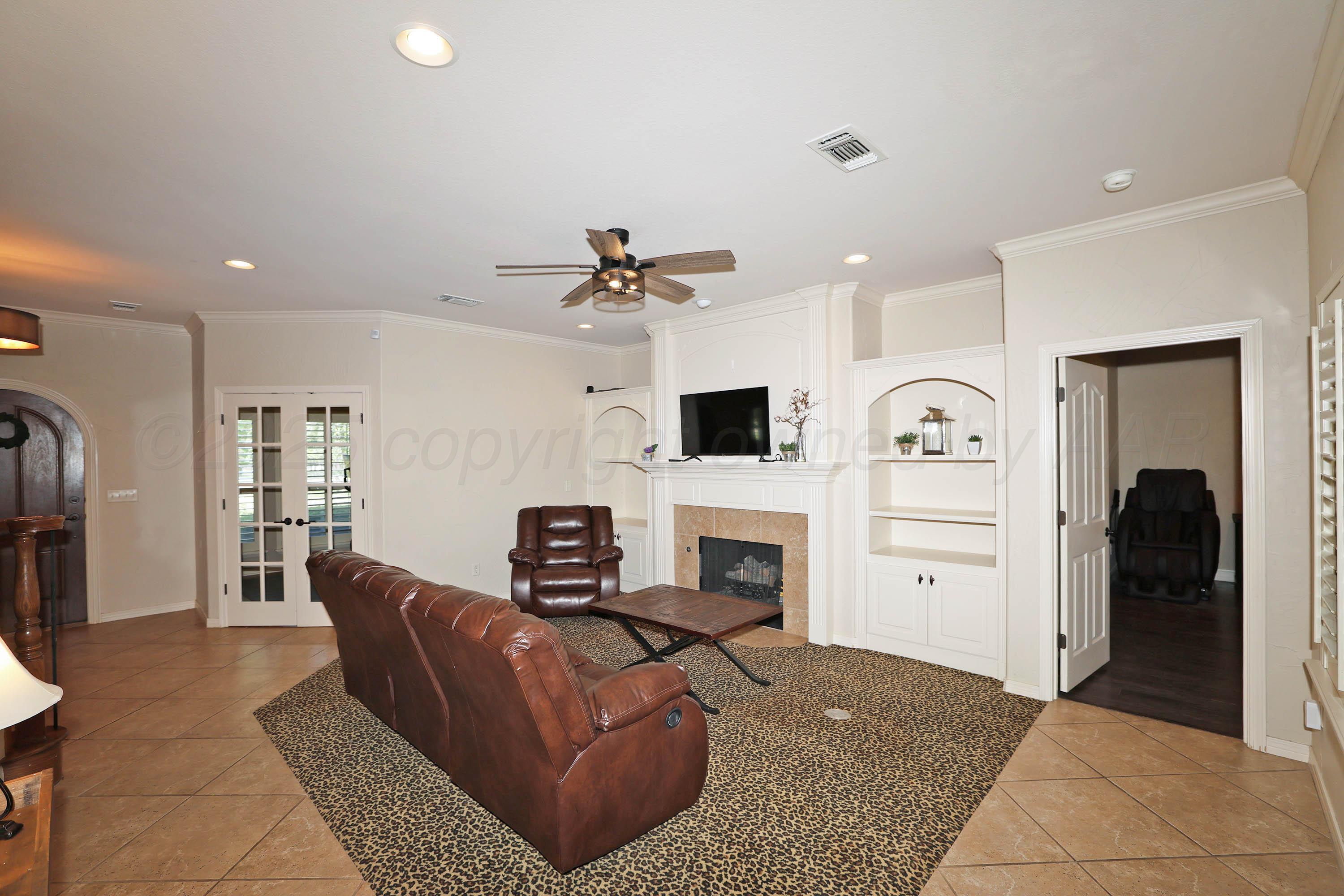 9220 Greyhawk Road Amarillo, TX 79119 - Photo 14 of 50 a living room with furniture and a fireplace