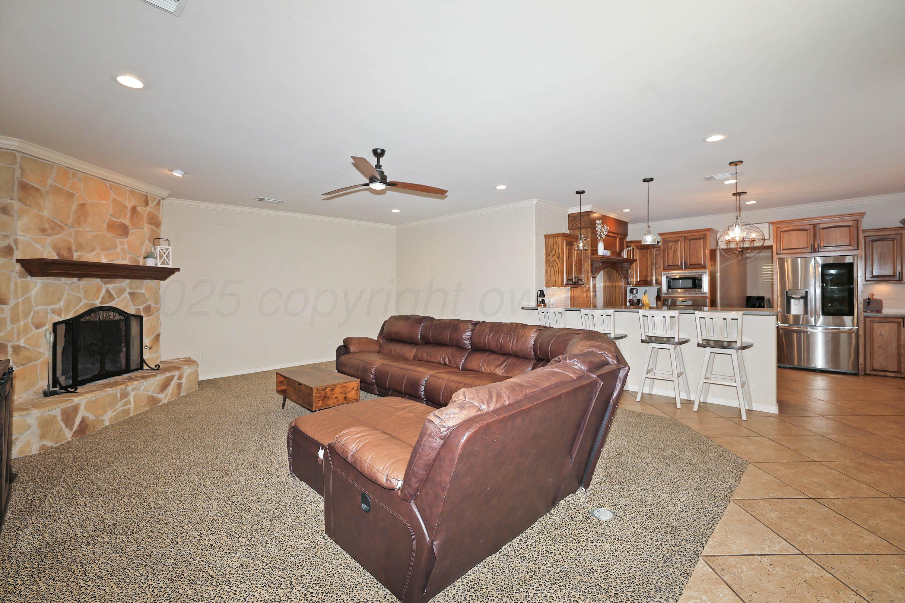 9220 Greyhawk Road Amarillo, TX 79119 - Photo 16 of 50 a living room with furniture and a fireplace