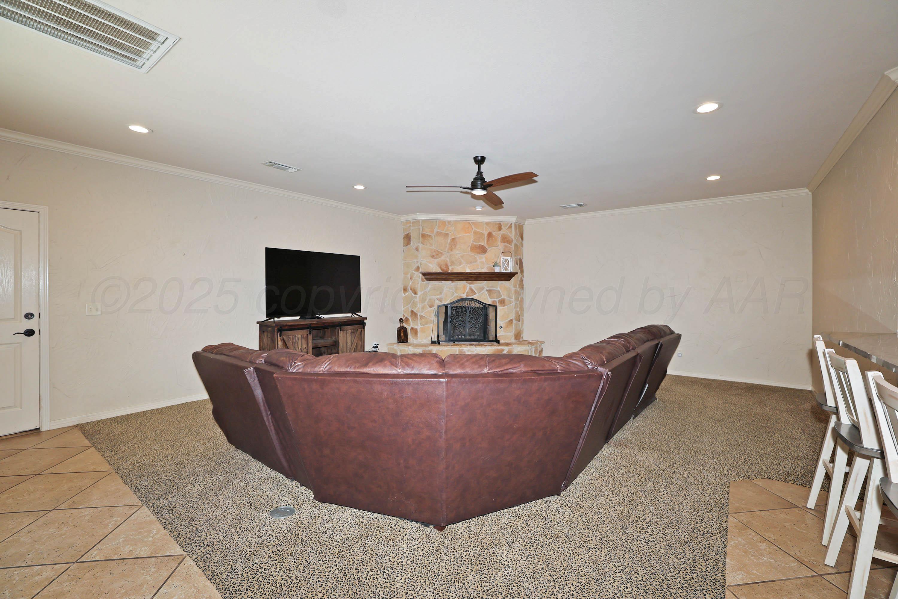 9220 Greyhawk Road Amarillo, TX 79119 - Photo 17 of 50 a living room with furniture and a flat screen tv