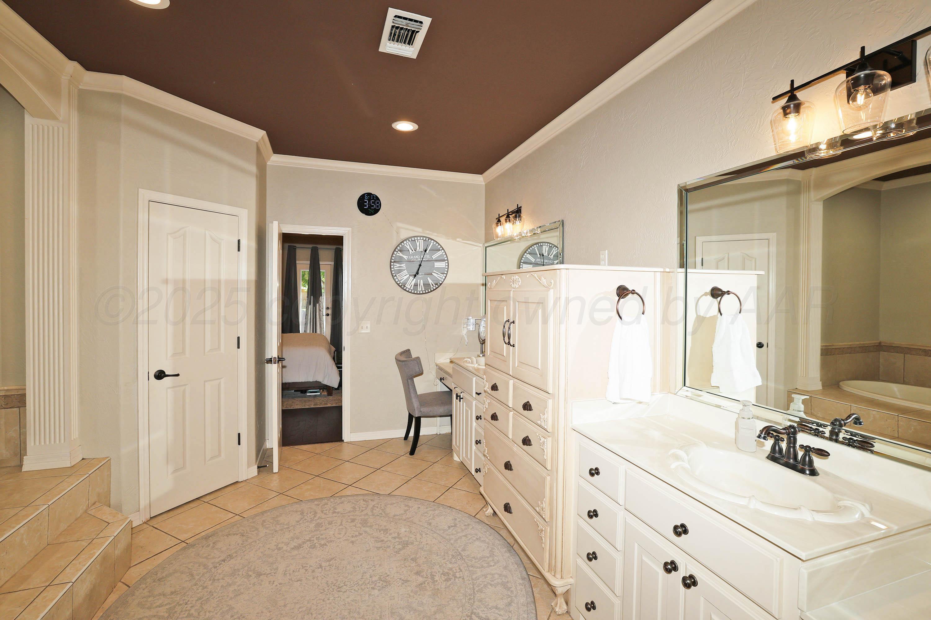 9220 Greyhawk Road Amarillo, TX 79119 - Photo 21 of 50 a bathroom with a double vanity sink mirror and shower