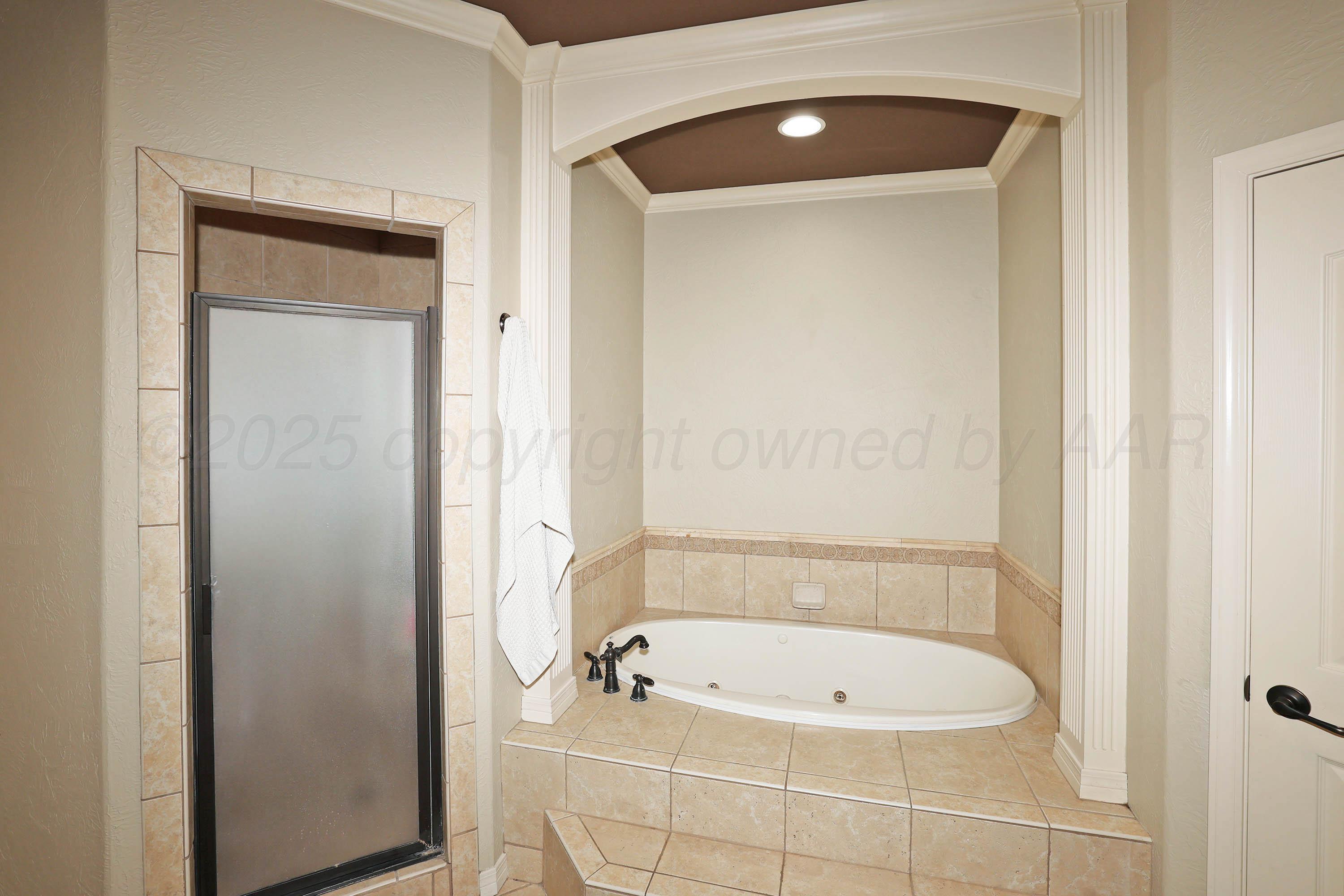 9220 Greyhawk Road Amarillo, TX 79119 - Photo 22 of 50 a bathroom with a tub and shower