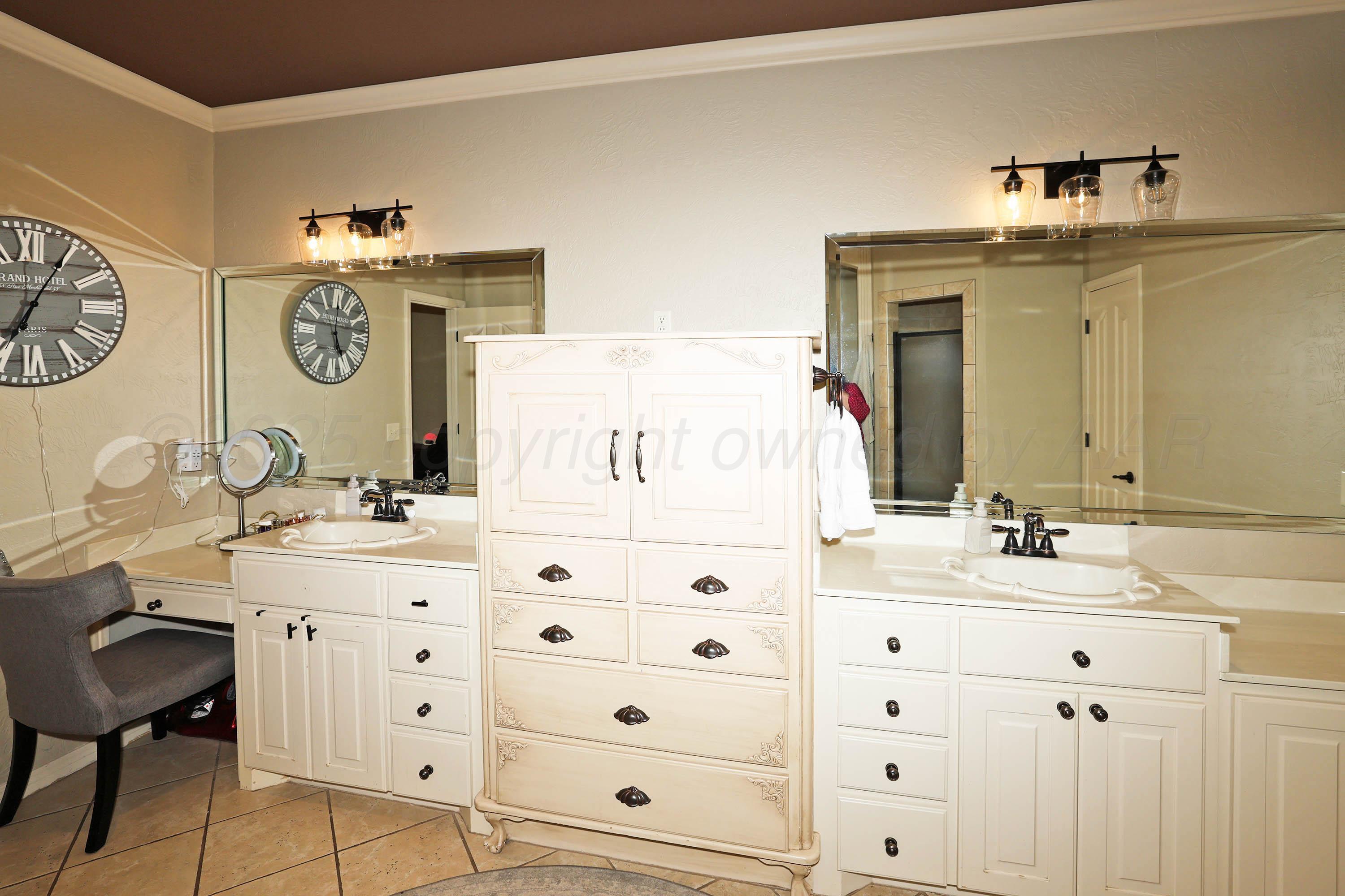 9220 Greyhawk Road Amarillo, TX 79119 - Photo 23 of 50 a bathroom with a sink vanity and a mirror