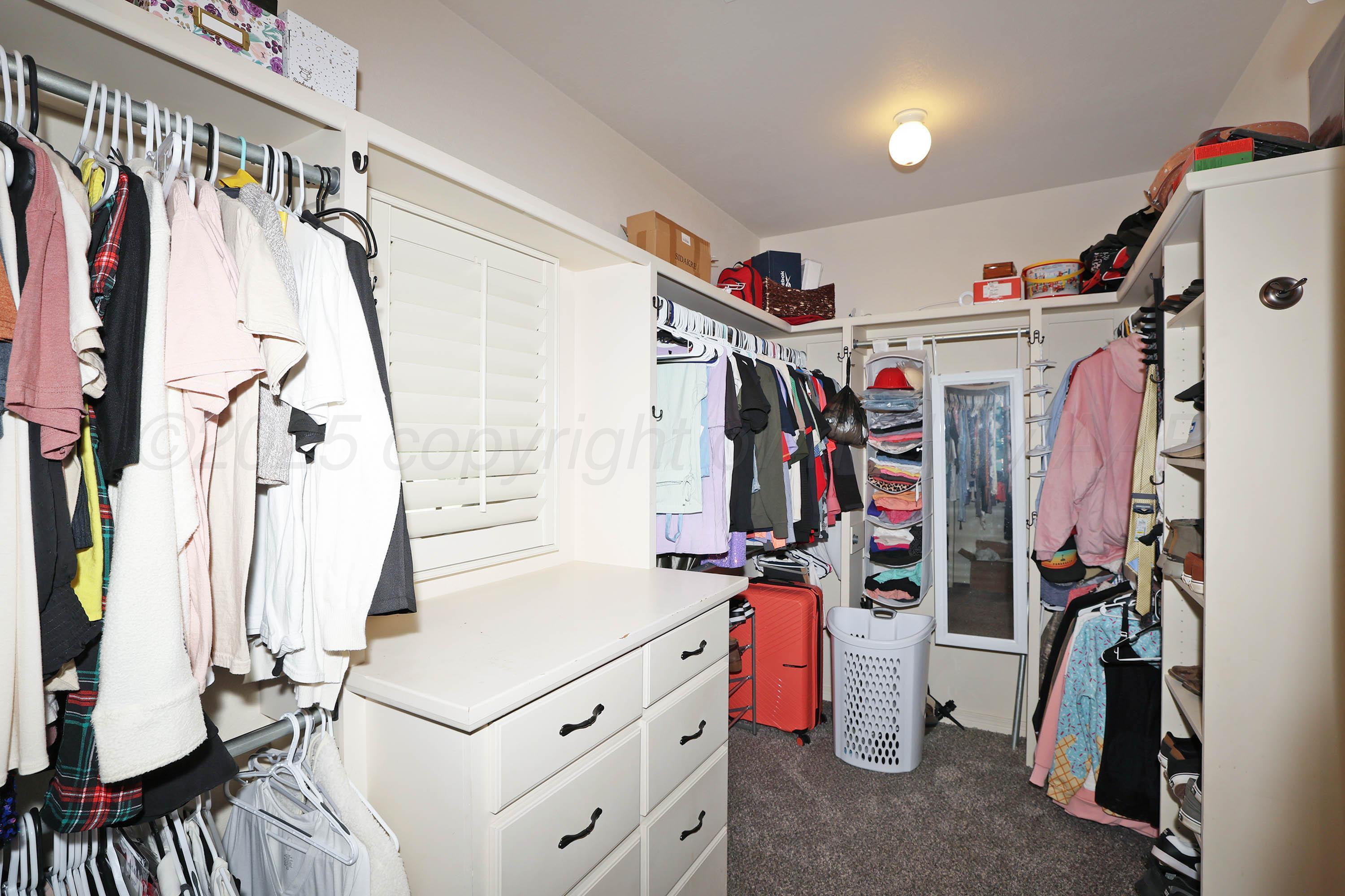 9220 Greyhawk Road Amarillo, TX 79119 - Photo 24 of 50 a view of walk in closet with clothes and shoes