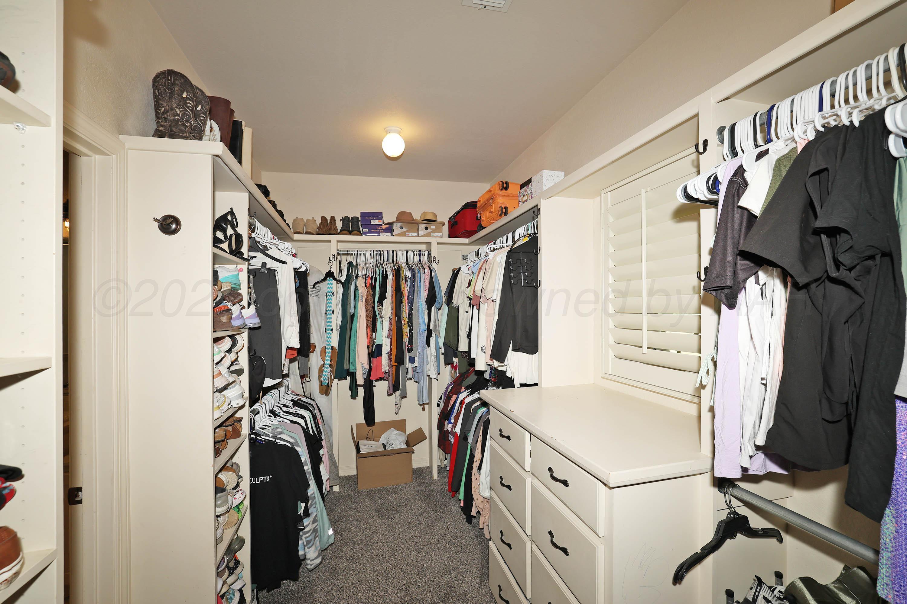 9220 Greyhawk Road Amarillo, TX 79119 - Photo 25 of 50 a view of walk in closet with clothes and shoes
