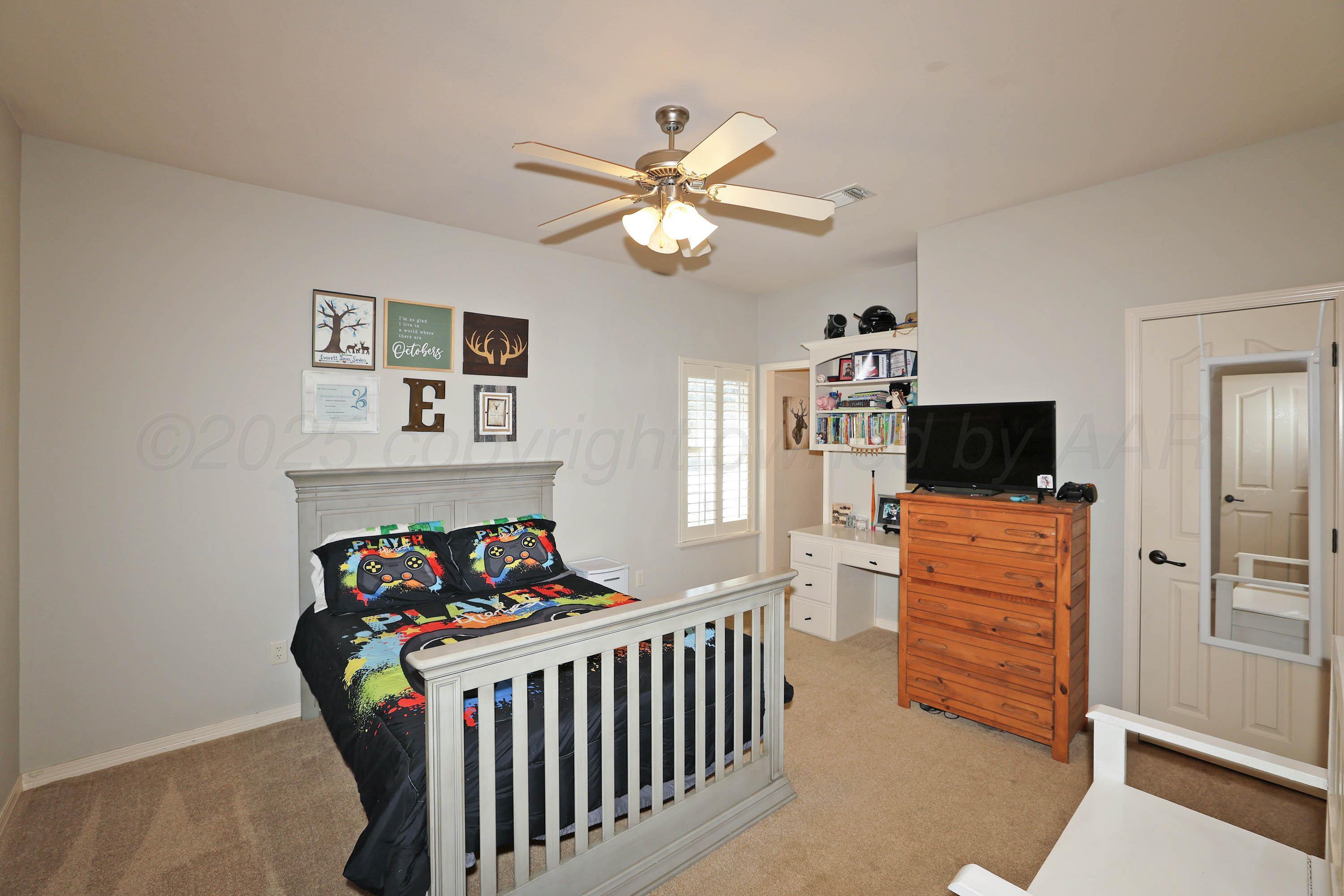 9220 Greyhawk Road Amarillo, TX 79119 - Photo 26 of 50 a bedroom with furniture and a window