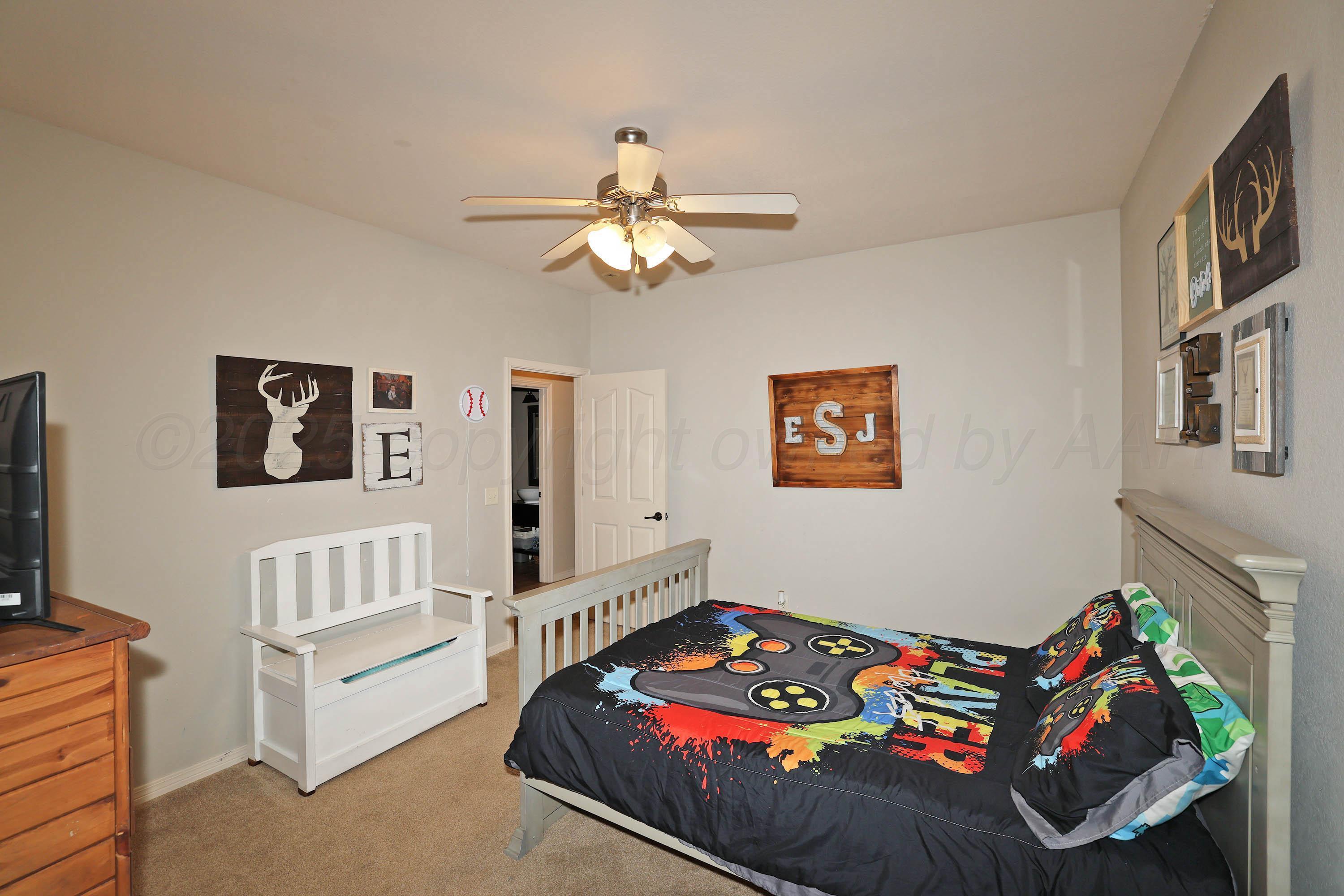 9220 Greyhawk Road Amarillo, TX 79119 - Photo 27 of 50 a bedroom with furniture and a chandelier