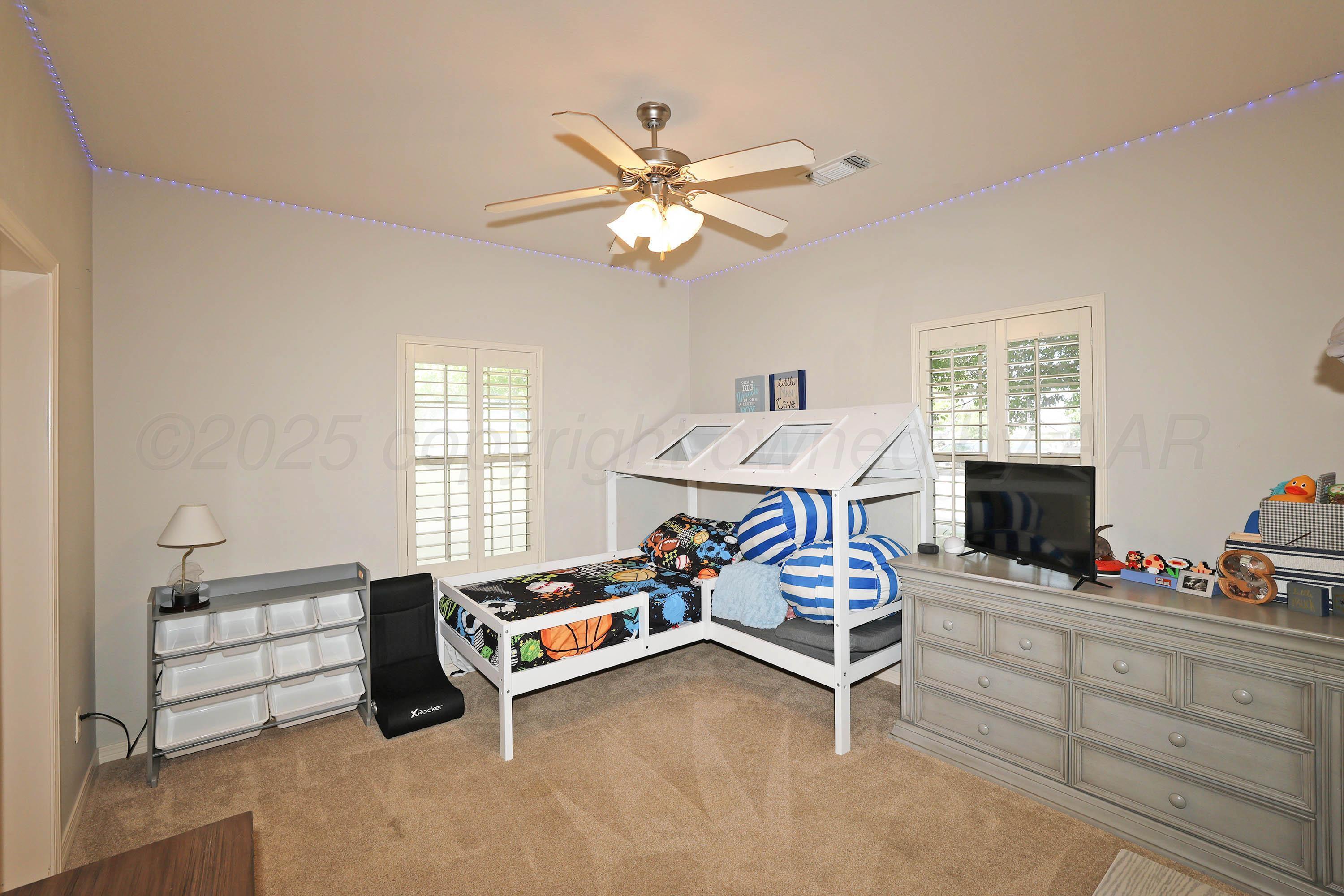 9220 Greyhawk Road Amarillo, TX 79119 - Photo 29 of 50 a bedroom with furniture and a window
