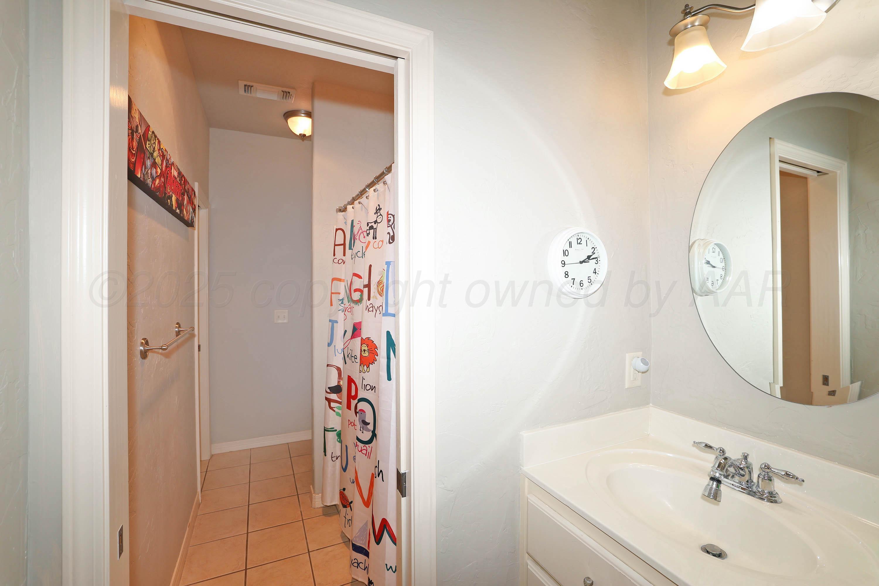 9220 Greyhawk Road Amarillo, TX 79119 - Photo 31 of 50 a bathroom with a sink mirror and vanity
