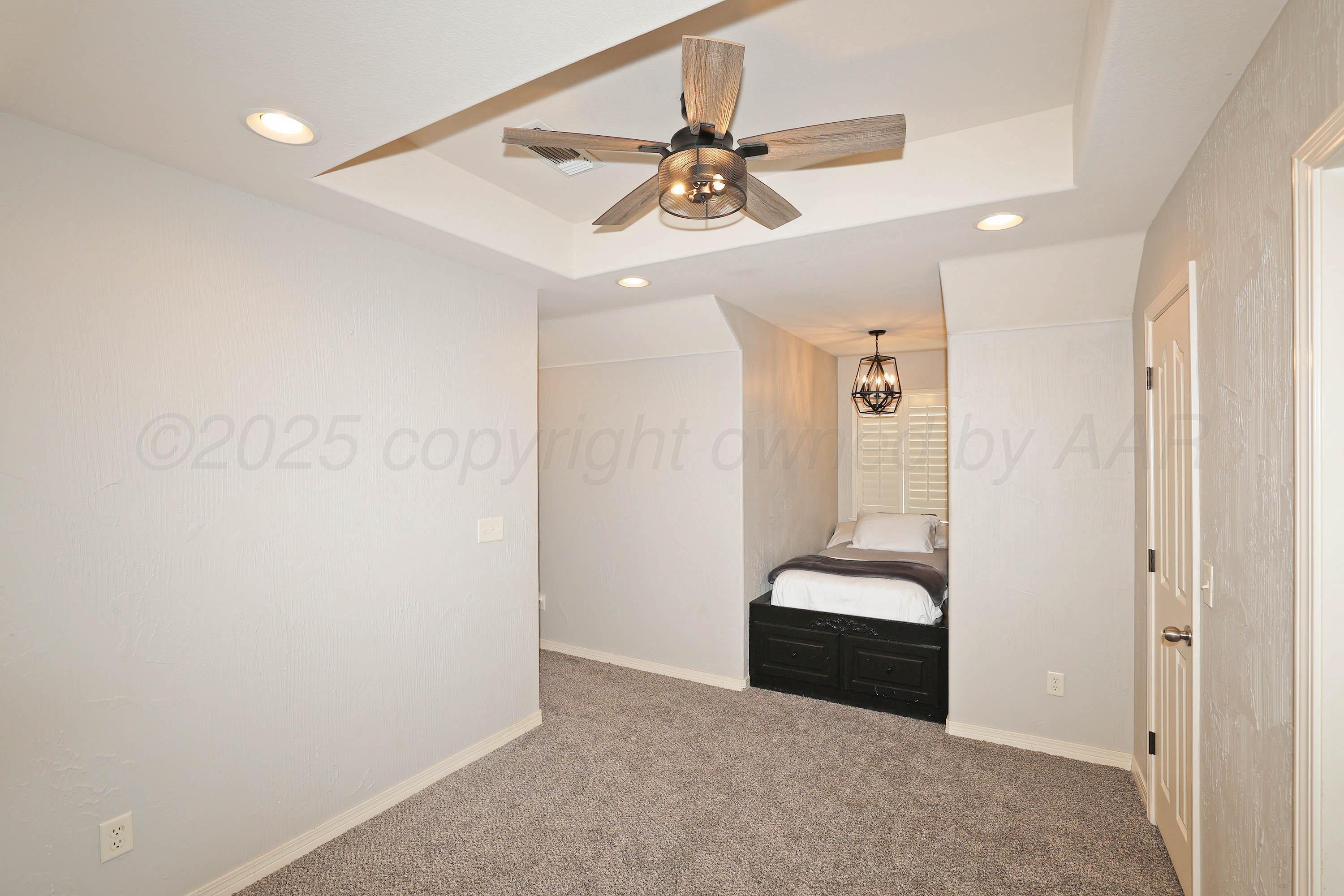 9220 Greyhawk Road Amarillo, TX 79119 - Photo 33 of 50 a view of a hallway with a couch and a ceiling fan