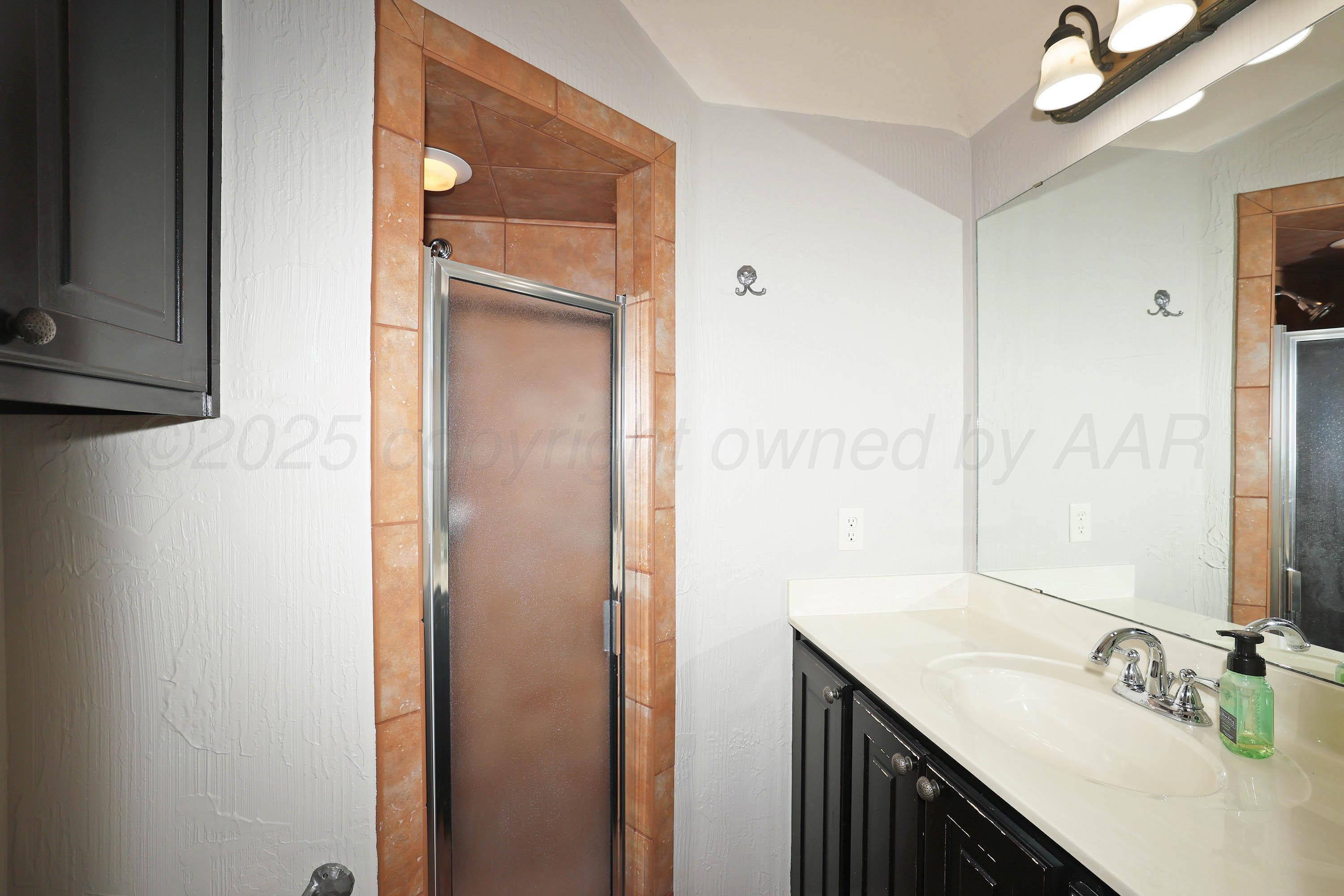 9220 Greyhawk Road Amarillo, TX 79119 - Photo 35 of 50 a bathroom with a granite countertop sink and a mirror