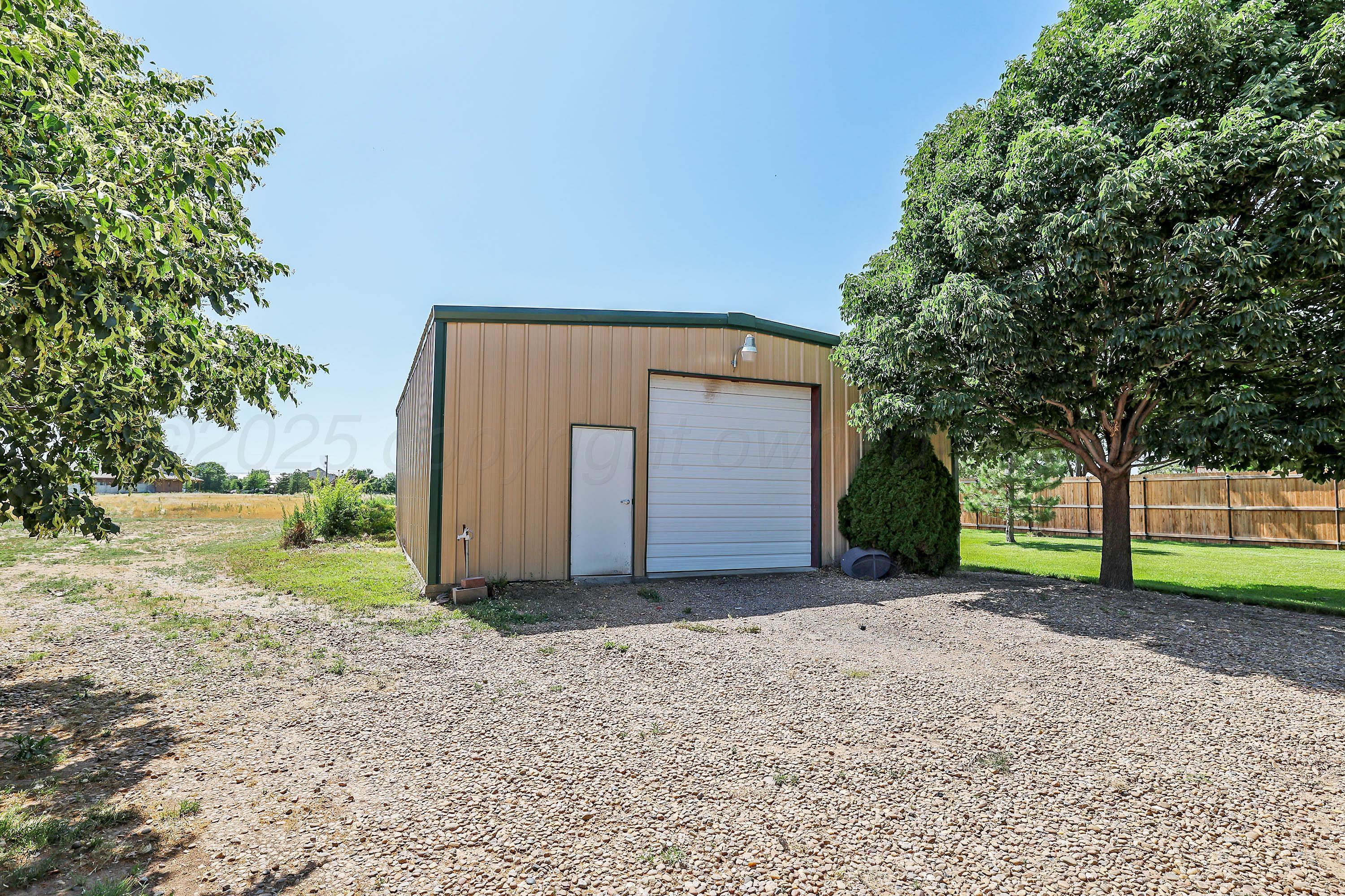 9220 Greyhawk Road Amarillo, TX 79119 - Photo 38 of 50 a view of a house with a yard and large tree