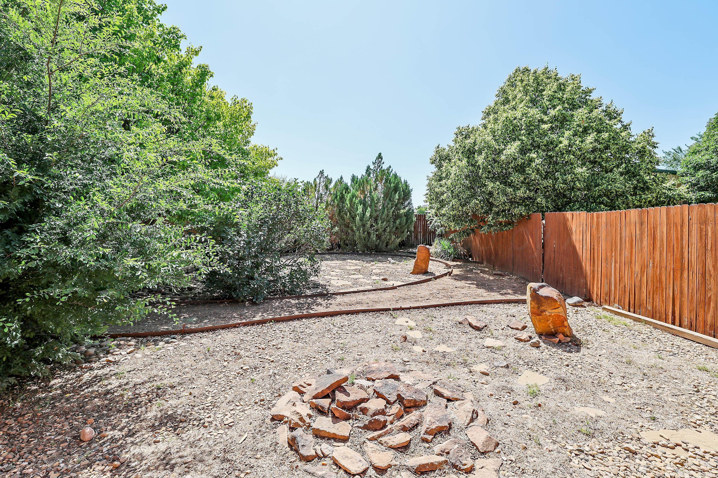 9220 Greyhawk Road Amarillo, TX 79119 - Photo 46 of 50 a view of a backyard with large trees