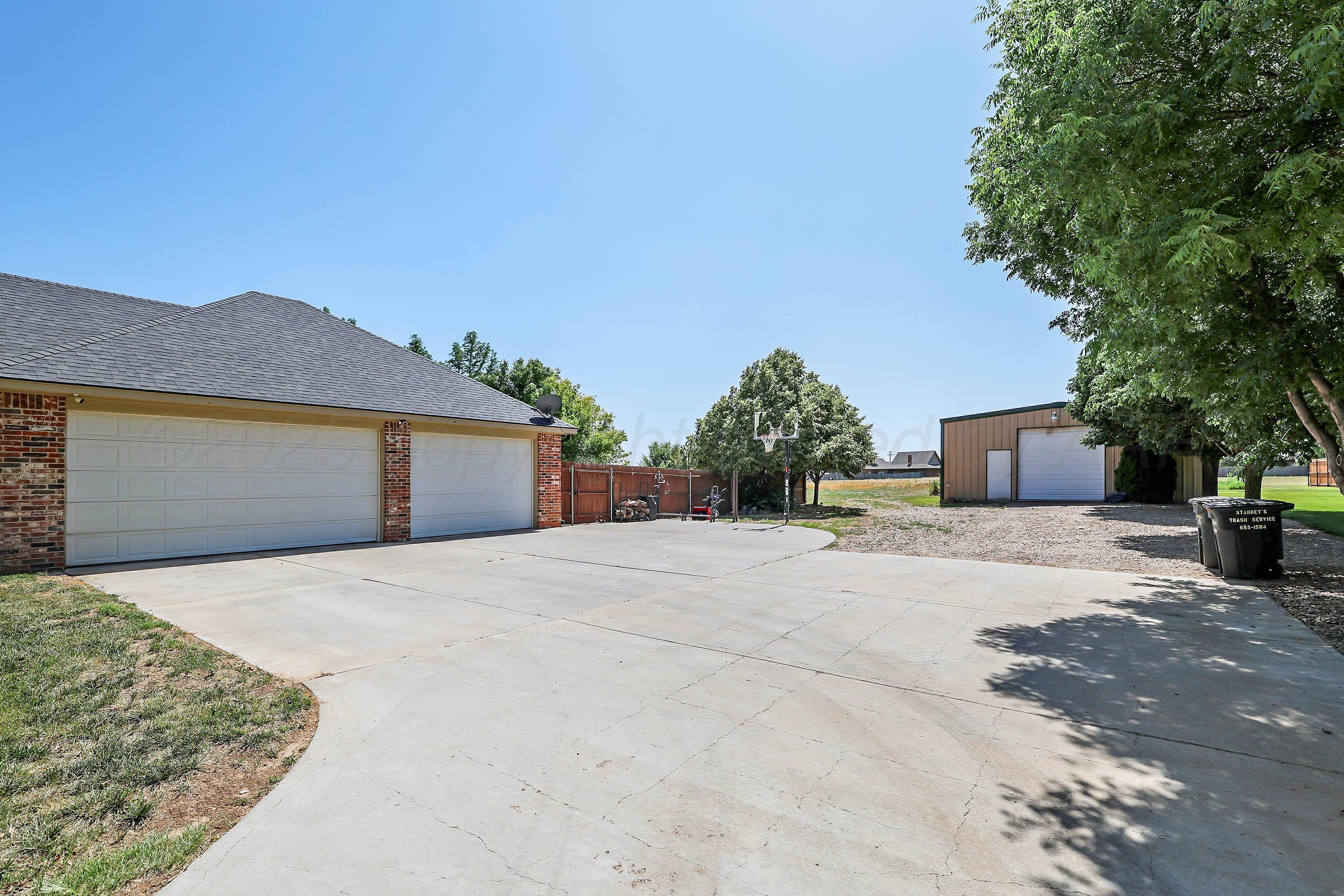 9220 Greyhawk Road Amarillo, TX 79119 - Photo 48 of 50 a front view of a house with a yard and garage