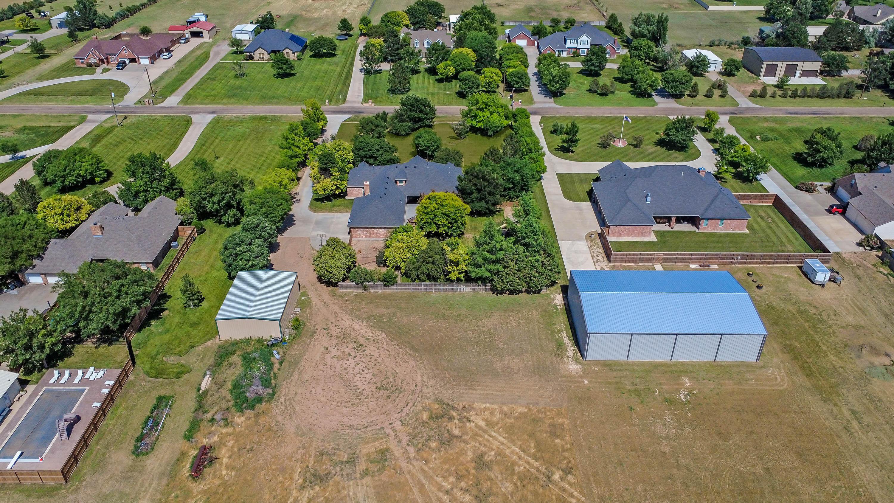 9220 Greyhawk Road Amarillo, TX 79119 - Photo 5 of 50 an aerial view of house with yard swimming pool and outdoor seating