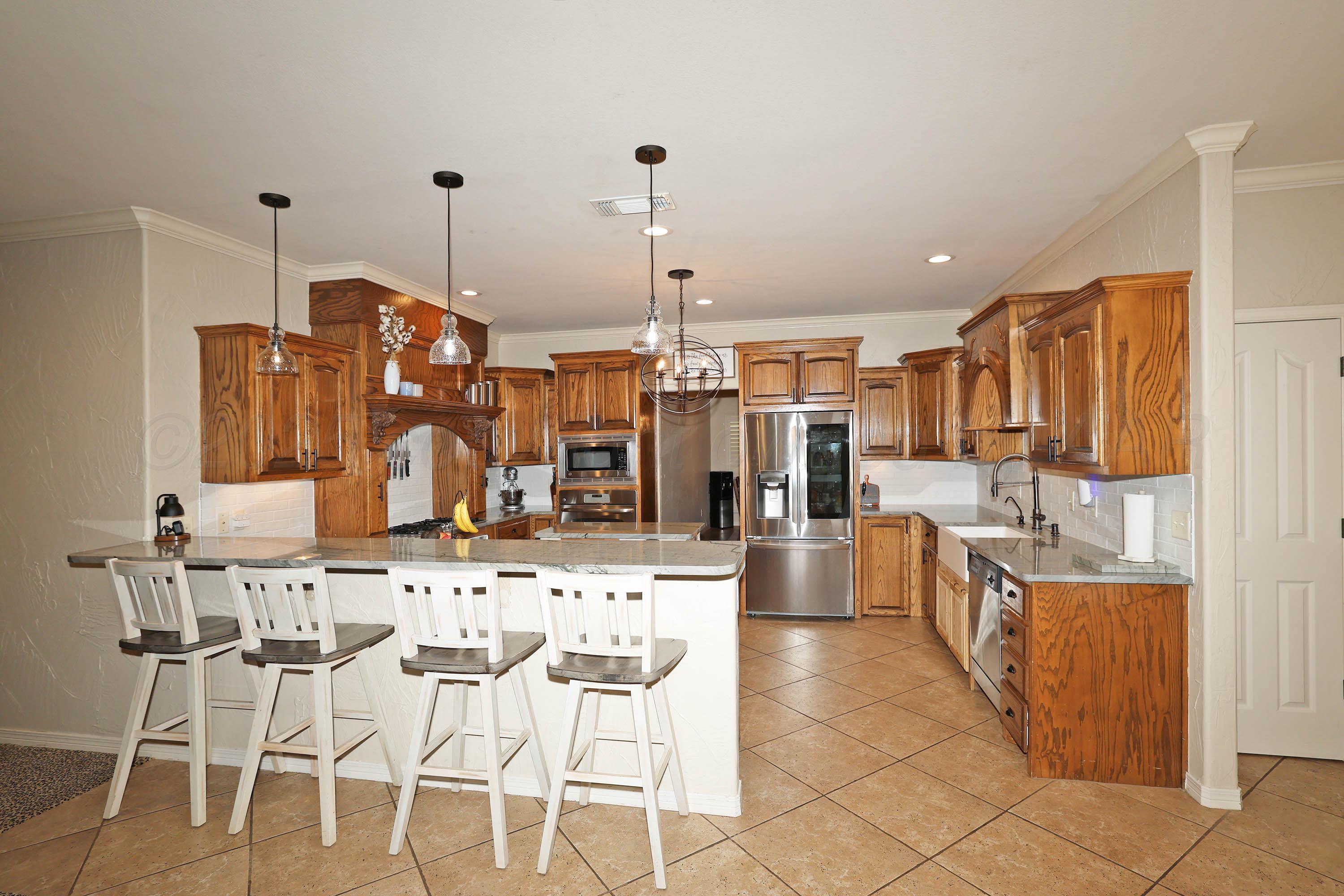 9220 Greyhawk Road Amarillo, TX 79119 - Photo 10 of 50 a large kitchen with a table and chairs