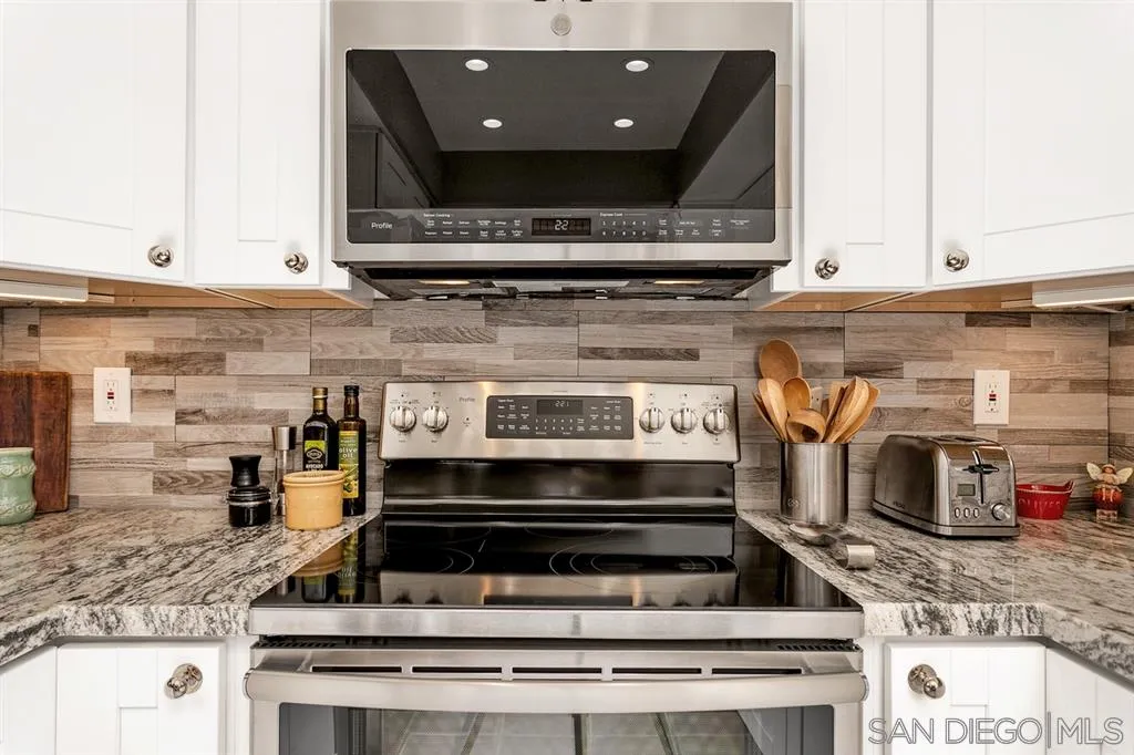 13955 Midland Road Poway, CA 92064 - Photo 12 of 25 a stove top oven sitting inside of a kitchen