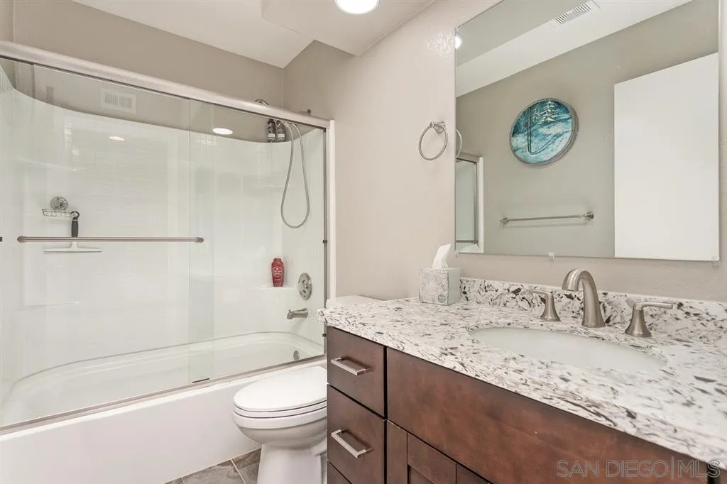13955 Midland Road Poway, CA 92064 - Photo 14 of 25 a bathroom with a granite countertop sink toilet and shower