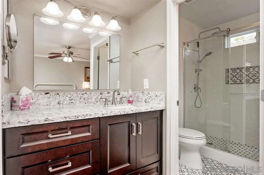 13955 Midland Road Poway, CA 92064 - Photo 19 of 25 a bathroom with a granite countertop sink toilet and shower