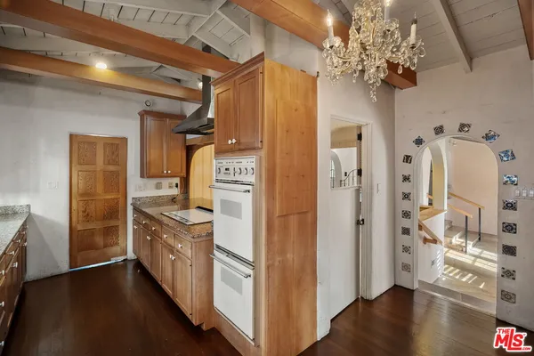 a kitchen with stainless steel appliances granite countertop a refrigerator and a stove