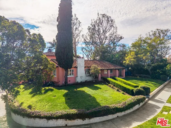 a view of a house with swimming pool and a yard