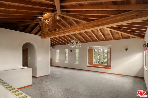 a view of an empty room with windows